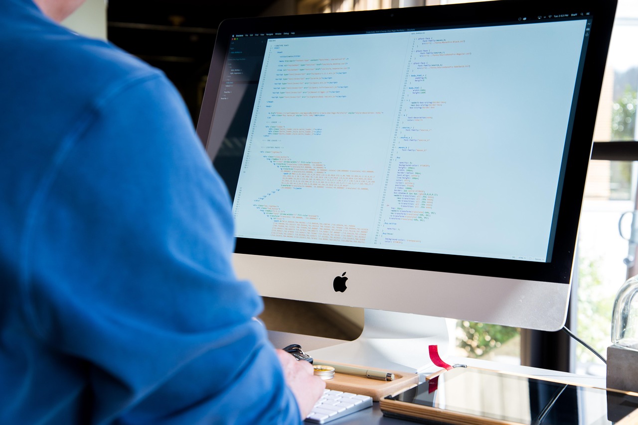 A developer reviewing code on a desktop screen